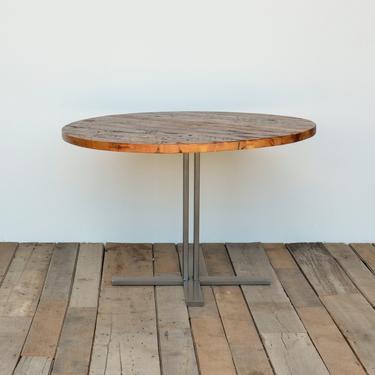 Round pedestal dining table in reclaimed wood and steel legs in your choice of color, size and finish.  Custom inquiries welcome. 