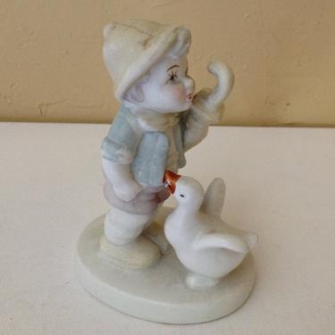 Vintage Adorable figurine of a Boy holding an umbrella and Duck Figurine Porcelain Bisque finish 