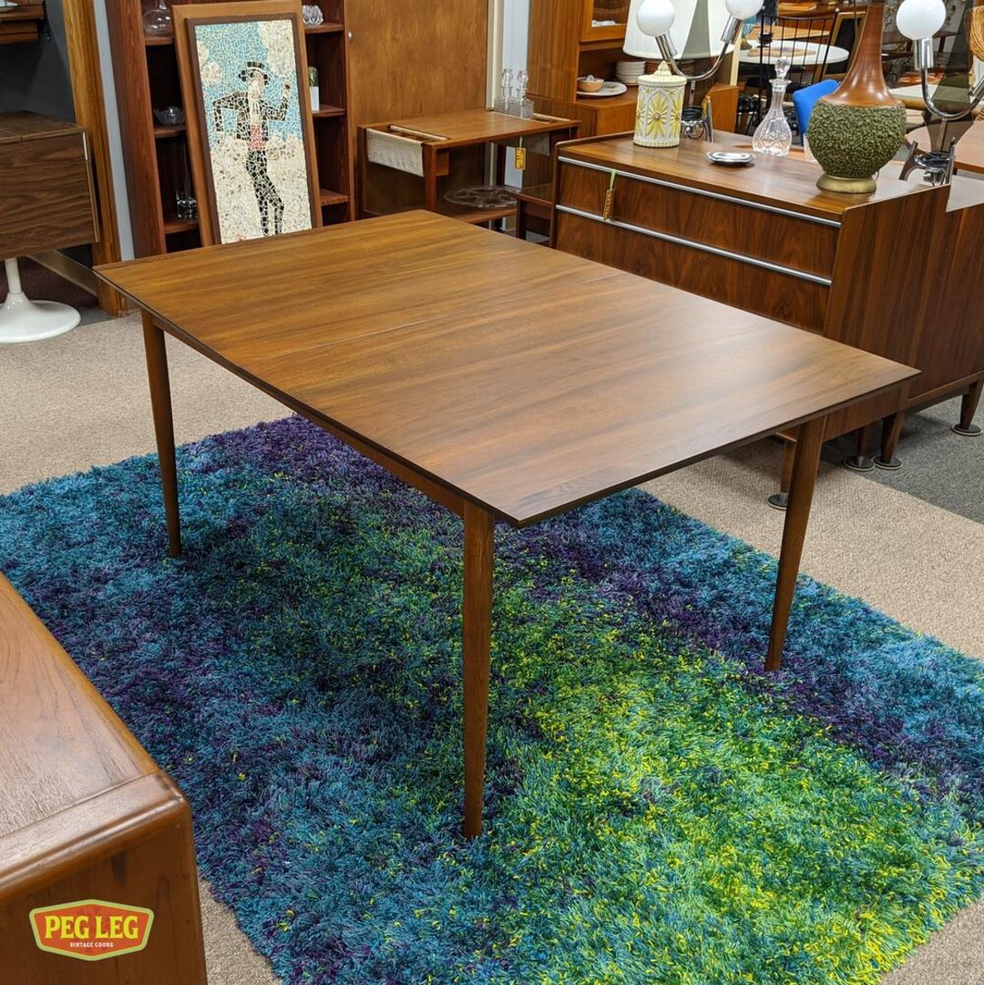 Walnut boatshape dining table from the Perspecta collection by Kent