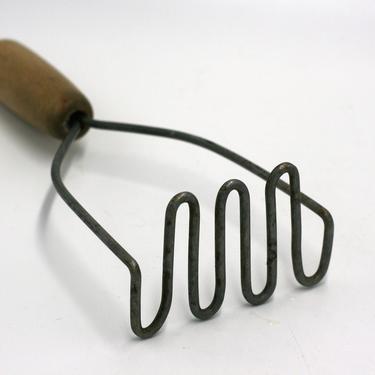 vintage potato masher with wooden handle 