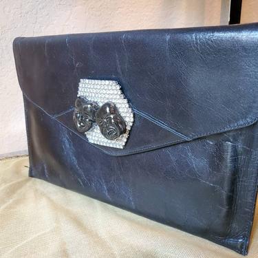 Black leather clutch envelope style with a clear rhinestone deco and ceramic drama faces designed by Amanda Alarcon-Hunter for Minx and Onyx 