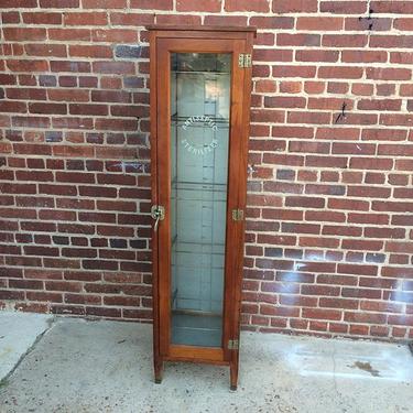 Standing vintage medicine cabinet with glass front