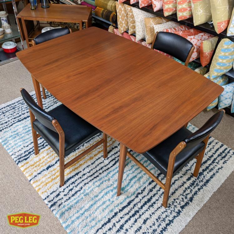 MidCentury Modern walnut boatshaped dining table with one extension