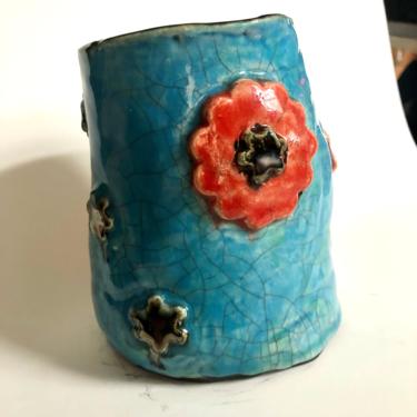 Hand built ceramic blue turquoise crackle vase with red/orange and silver floral. 5.5” H x 4.5” W 