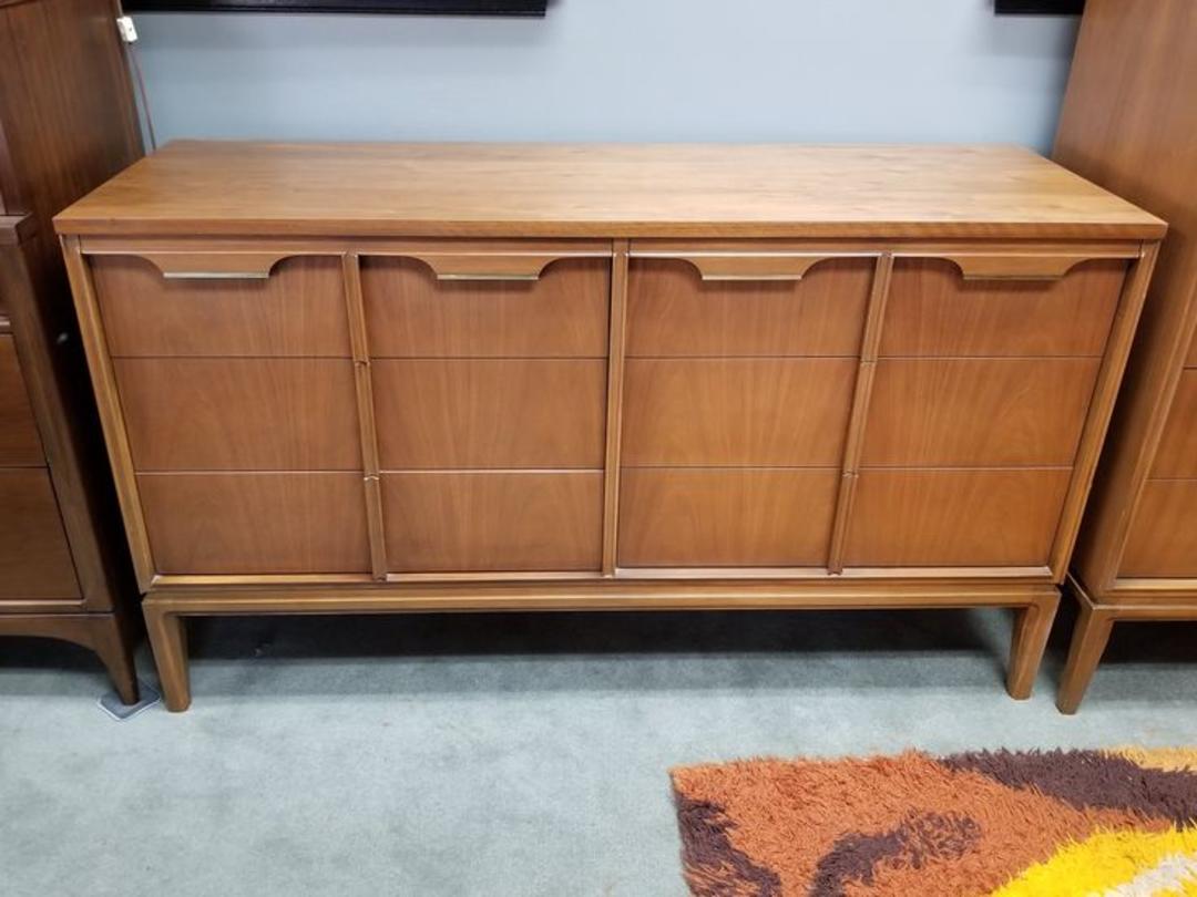 MidCentury Modern walnut dresser with sculpted pulls and brass accents