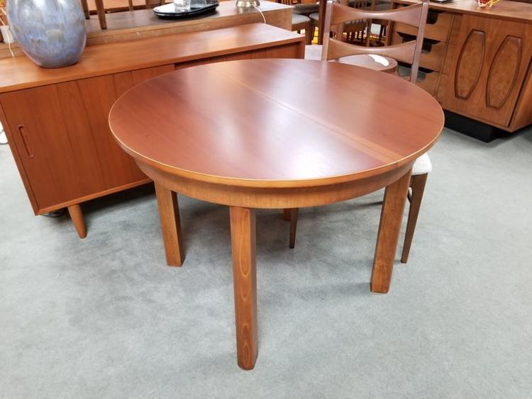 Mid-Century Modern round makore wood dining table with butterfly leaf