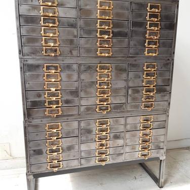 Vintage industrial stripped steel file cabinet. 
