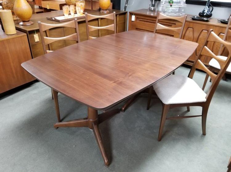 Mid-Century Modern walnut boat shaped dining table with a double pedestal base