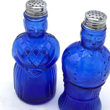 Vintage pair of Aunt Jemima and Mose Figure Cobalt Blue Glass salt and pepper shakers with metal caps 