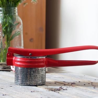 Vintage potato ricer / red and silver metal masher / fruit juicer / red kitchen decor / rustic farmhouse decor 