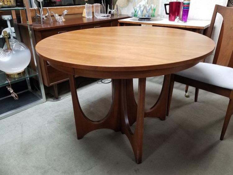 Mid-Century Modern round walnut dining table with one 12"leaf from the Brasilia collection by Broyhill