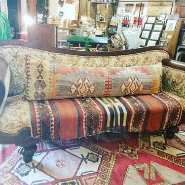 Antique Sofa with hand carved arms and legs. $700