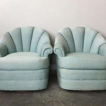 pair of vintage teal shell back swivel chairs.