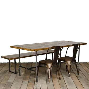 Reclaimed wood dining table with 1.5" reclaimed wood top and steel pipe legs 