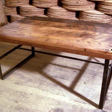 Reclaimed wood coffee table with industrial metal base 
