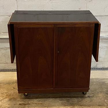 MCM rosewood bar cart with drop leaf black lacquer top on casters 32.5” l x 18” d x 34” ht ( 64” length expanded) 