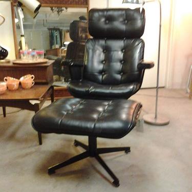 Tufted black hide on chair and matching otto and iron frame set this swivel lounge chair apart.  Waiting to lull  you at Hunted House,