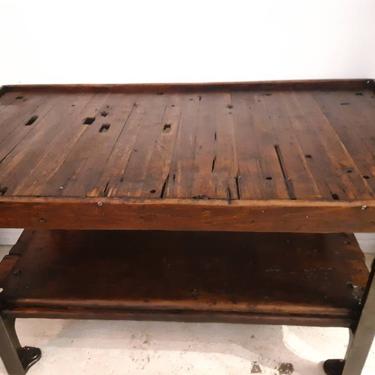 Vintage industrial factory work table with cast iron legs and shelf 