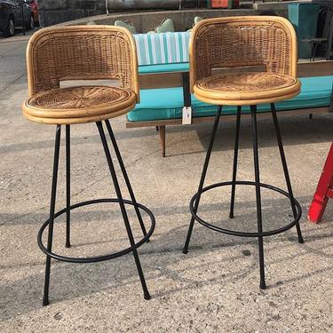                   A pr of Mid Century cane and metal swivel barstools, by Danny