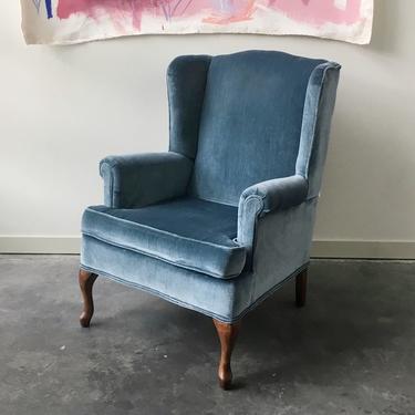 vintage blue velvety wingback chair.