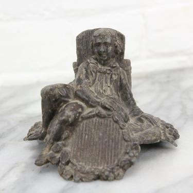 Cast Metal Match Stick Holder with Young Boy Leaning Against a Bucket 