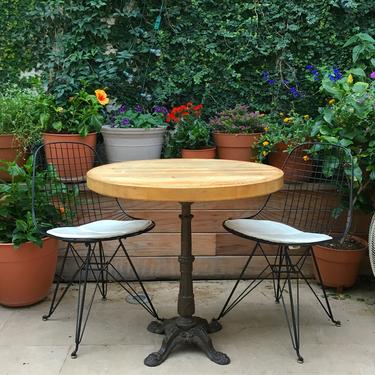 bistro table with wooden top and wrought iron base