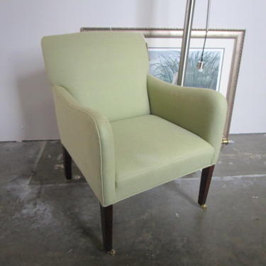 NEW UPHOLSTERED ARM CHAIR WITH CASTERS
