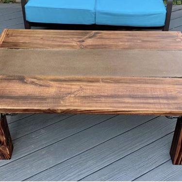 Coffee Table. Stained High Density Concrete Center, with Black Epoxy filled spots, Honey Stained Shou Sugi Ban Wood frame and base, with Black Steel Pipe Accents