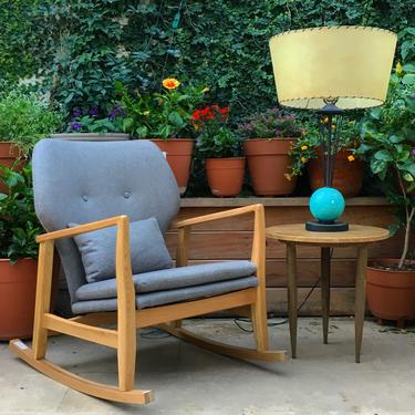 grey mid century modern style rocking chair with wooden frame