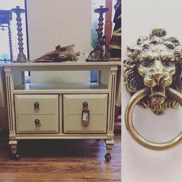 Vintage tea/bar cart, fitted with brass lion's head drawer pulls. Brass casters. $250
