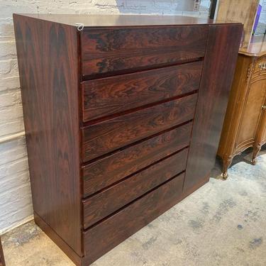 Danish made rosewood chest with 12 drawers. 6 shallow pull out drawers behind a door.