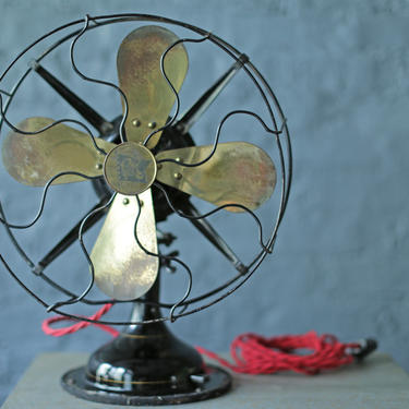 vintage oscillating cast iron base and brass blade fan by Robbins and Myers Co, circa 1920 