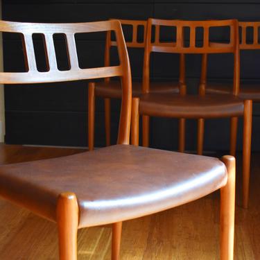 Four Danish teak Niels Moller 79 dining chairs w/brown faux leather 