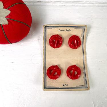 Red plastic anchor buttons on card - 3/4