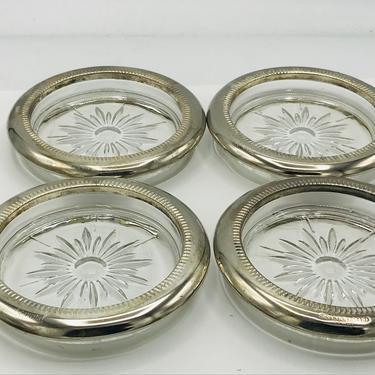Four (4) vintage coasters from silver plate with  cut glass or crystal centers 