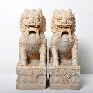 A pair of Carved Stone Lion Sculptures