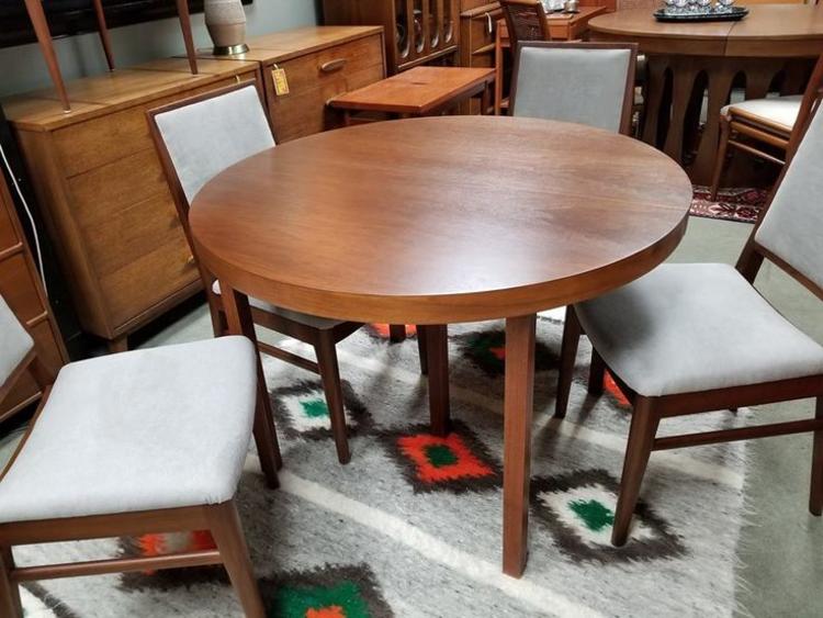 Mid-Century Modern 42"round walnut dining table with four 18" leaves by John Stuart