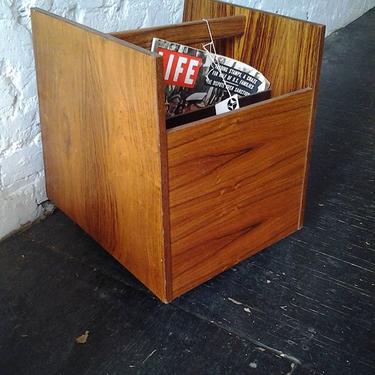 Teak 4 - compartment rolling magazine cart from Bruksbo of Sweden is quite a chic accent piiece.