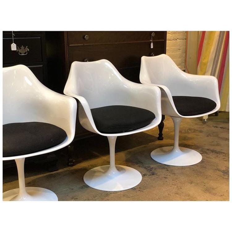 Shell white Tulip chairs with armrest/ black cushion. 3 available. 37 w x 33 h (b) x 24 d 