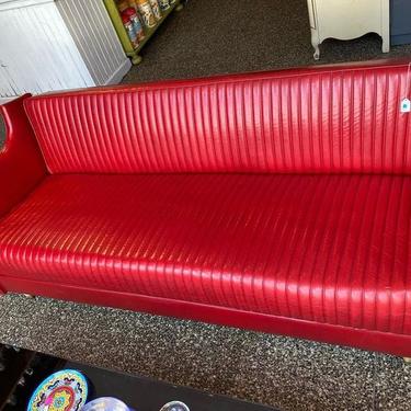 Hollywood regency style red vinyl convertible sofa.  78.5” x 33” x 26.5 seat height height 17”