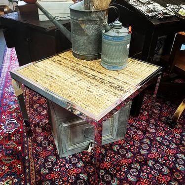                   Mid Century Modern, chrome and rattan side table.