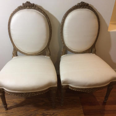 Pair of French King Louis style finely carved gilt wood side chairs. 