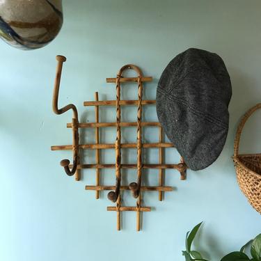 Vintage bamboo, cane rattan hat rack. Criss-crossed cane and bamboo, laced together with rattan strips. Six hooks total. Lower corner has co 