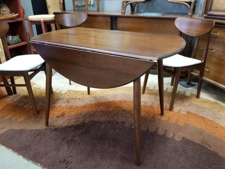 Mid-Century Modern round drop-leaf dining table with splayed legs