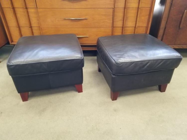 Pair of black leather ottomans