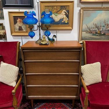4 drawer Basset dresser flanked by stoic deep red velvet chairs