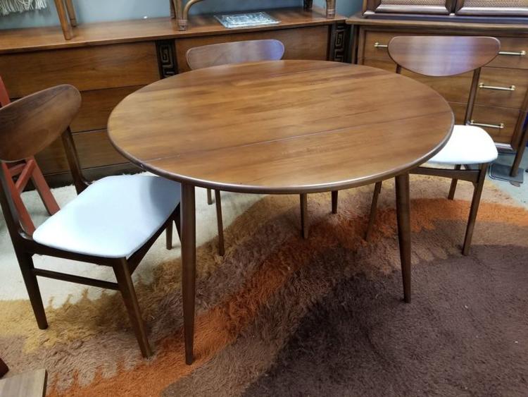 Mid-Century Modern round drop-leaf dining table with splayed legs