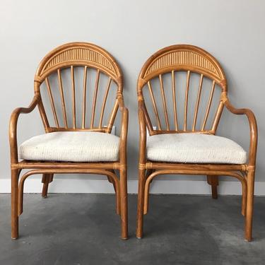 pair of vintage rattan arm chairs.