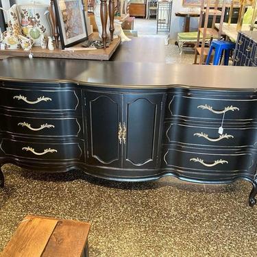 Lightly distressed black French provincial triple dresser with drawers behind doors. 72” x 21” x 33”
