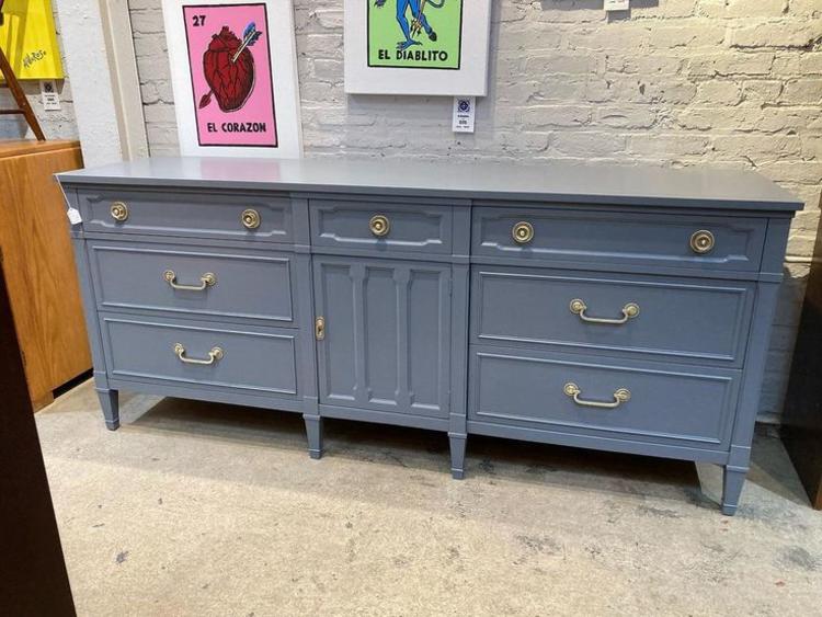 Gray painted regency style dresser. Door hides two pull out drawers. Made by Drexel. 75” x 20” x32”